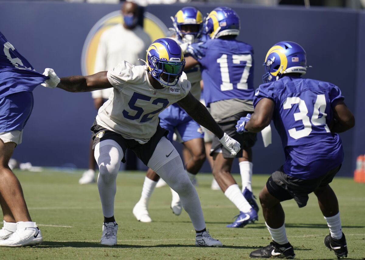 FILE - In this Aug. 27, 2020, file photo, Los Angeles Rams linebacker Terrell Lewis (52) defends against running back Malcolm Brown (34) during NFL football training camp in Thousand Oaks, Calif. Lewis will miss at least the first three weeks of his rookie season with the Rams due to a right knee problem that isn't as serious as Los Angeles first feared. Lewis will start the season on the non-football injury list, Rams coach Sean McVay said Wednesday, Sept. 9, as they began practice to face the Dallas Cowboys on Sunday night in SoFi Stadium's inaugural game. (AP Photo/Jae C. Hong, File)