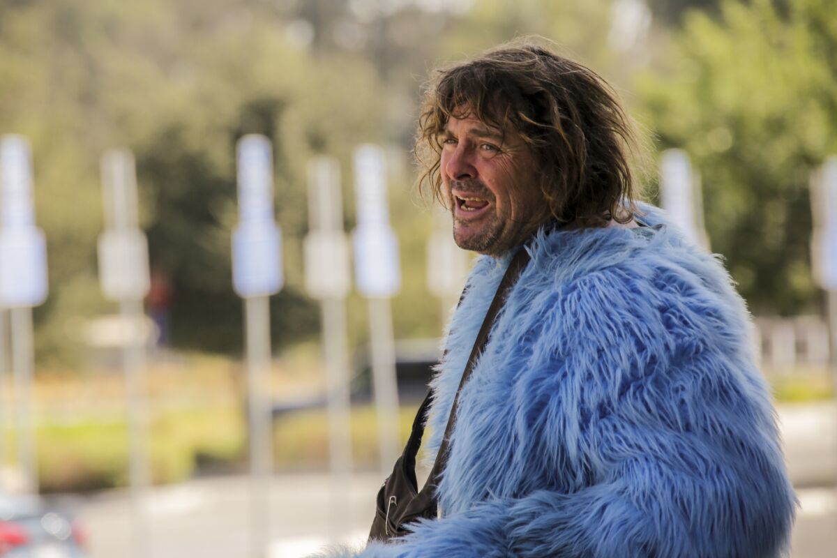 Adam Sandler without his Cookie Monster costume head outside the Los Angeles Zoo.