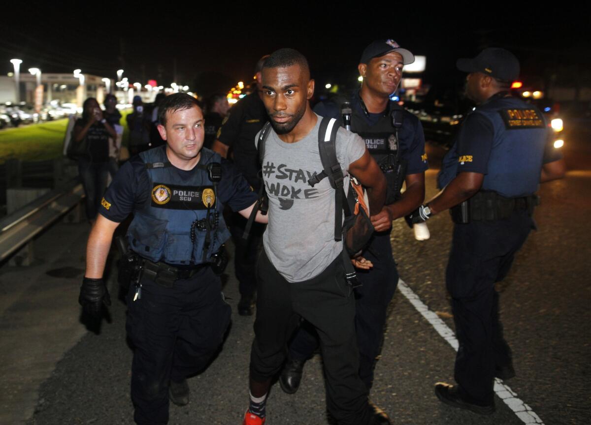 Police arrest activist DeRay McKesson during a protest along Airline Highway, a major road that passes in front of the Baton Rouge Police Department headquarters, on Saturday, July 9, 2016.