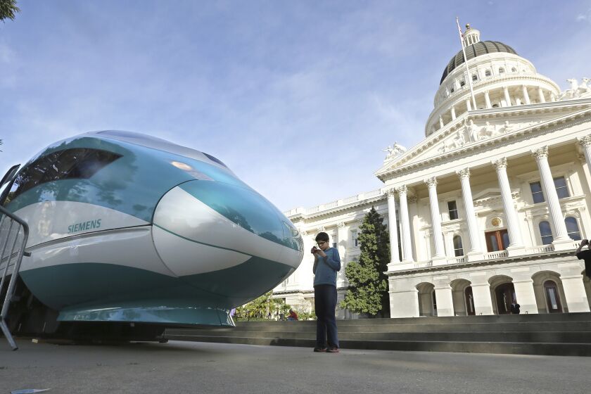 FILE — In this Feb. 26, 2015, file photo, a full-scale mock-up of a high-speed train is displayed at the Capitol in Sacramento, Calif. Lawmakers and the Newsom administration are still trying to reach agreement on whether to give the project $4.2 billion that's left in the bond fund voters approved for high-speed rail in 2008. Rail officials say the need it to continue construction beyond next summer, but some state lawmakers want more oversight of the project before releasing it. (AP Photo/Rich Pedroncelli, File)