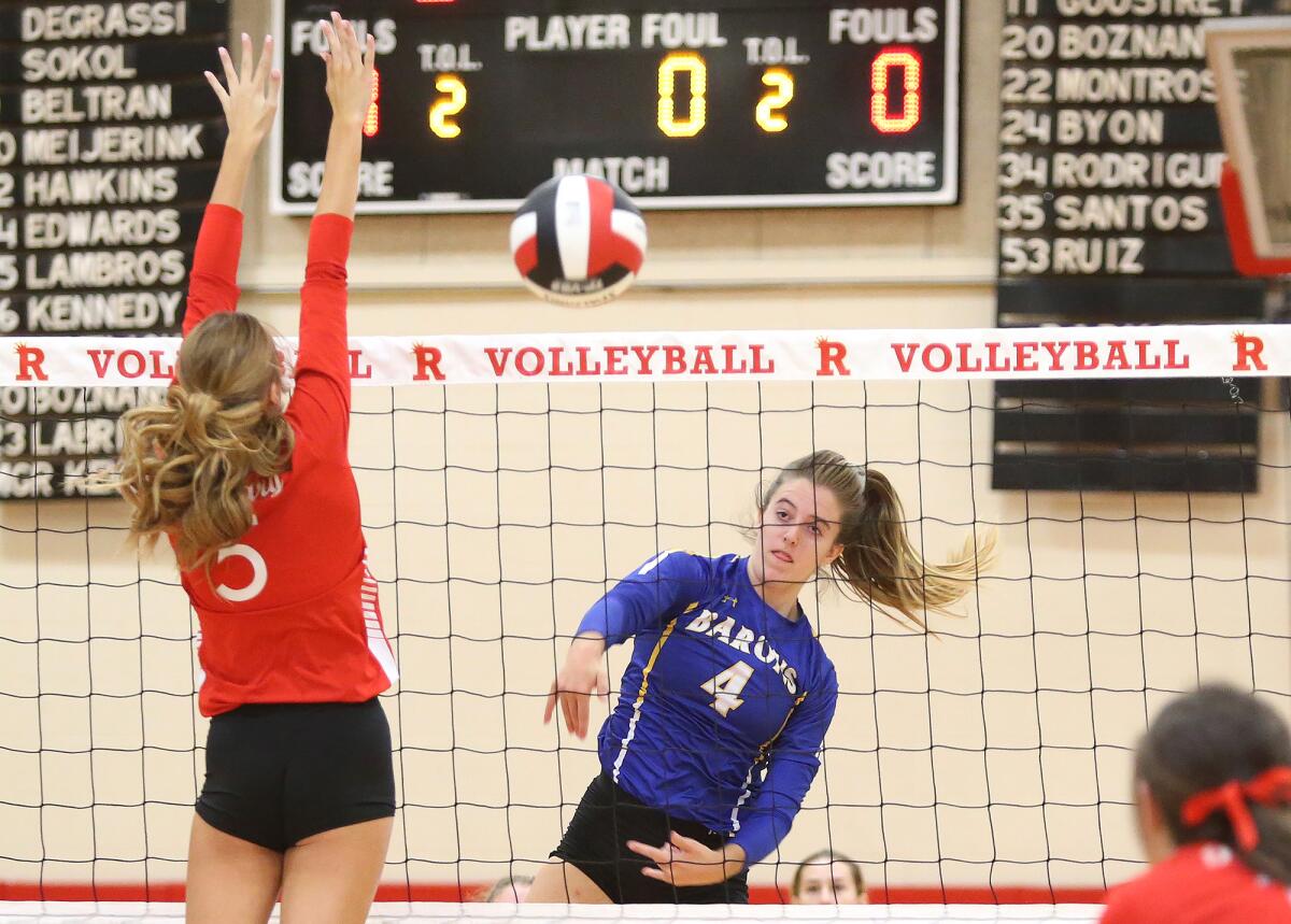 Fountain Valley's Phoebe Minch (4) gets a clean kill for point past Rosary's Sophia Degrassi (5) during a second-round match of the CIF Southern Section Division 3 playoffs on Saturday.