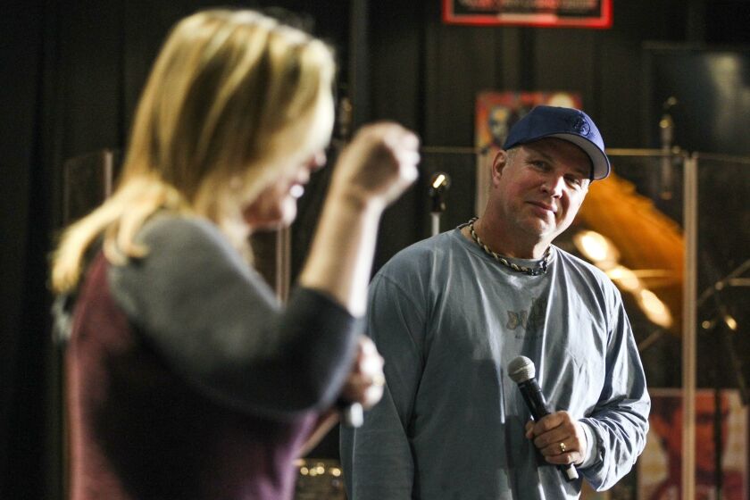 SAN DIEGO, CA, NOVEMBER 5, 2015 | Country music superstar Garth Brooks watches his wife and fellow country music singing star Trisha Yearwood talk to members of the media during a press conference before Brooks' first of a five concert series at the Valley View Casino Center in San Diego on Thursday. |_Mandatory Photo Credit: Photo by Hayne Palmour IV/San Diego Union-Tribune_©2015 San Diego Union-Tribune, LLC