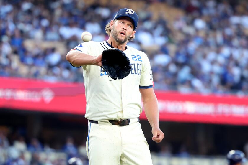 Dodgers pitcher Clayton Kershaw walks back to the mound after giving up a run to the Rays at Dodger Stadium.