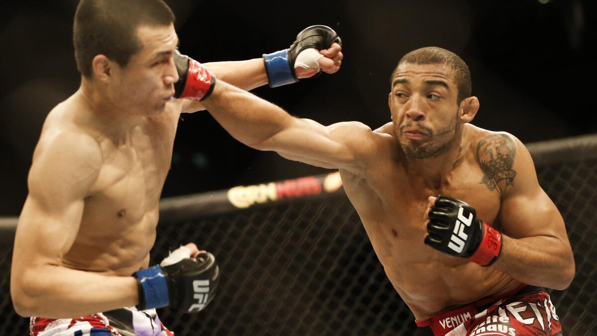 Jose Aldo, right, delivers a punch to the head of Chan Sung Jung during their featherweight championship bout at UFC 163 in 2013. Aldo is injured and likely will have to wait until October to defend his title against Chad Mendes.