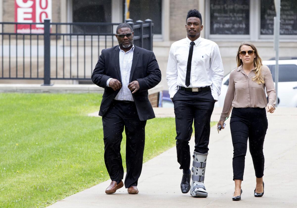 Notre Dame football player Devin Butler, center, walks into St. Joseph Superior Court, on Aug. 24.