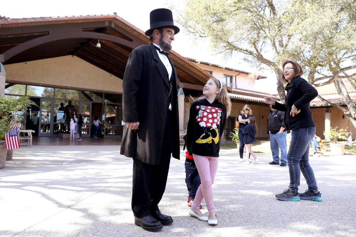 Fiona Floyd, 7, does a double take as she passes J.P. Wammach as President  Lincoln.