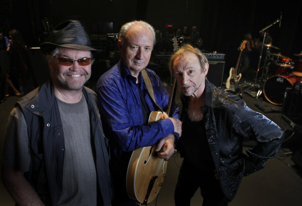 The Monkees surviving members, Micky Dolenz, from left, Michael Nesmith and Peter Tork, pose together in 2012.