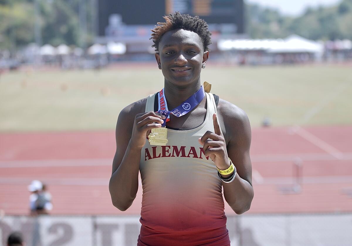 Bishop Alemany freshman Demare Dezeurn poses for a photo with his medal after winning the 100 meters at the Mt. SAC Relays.
