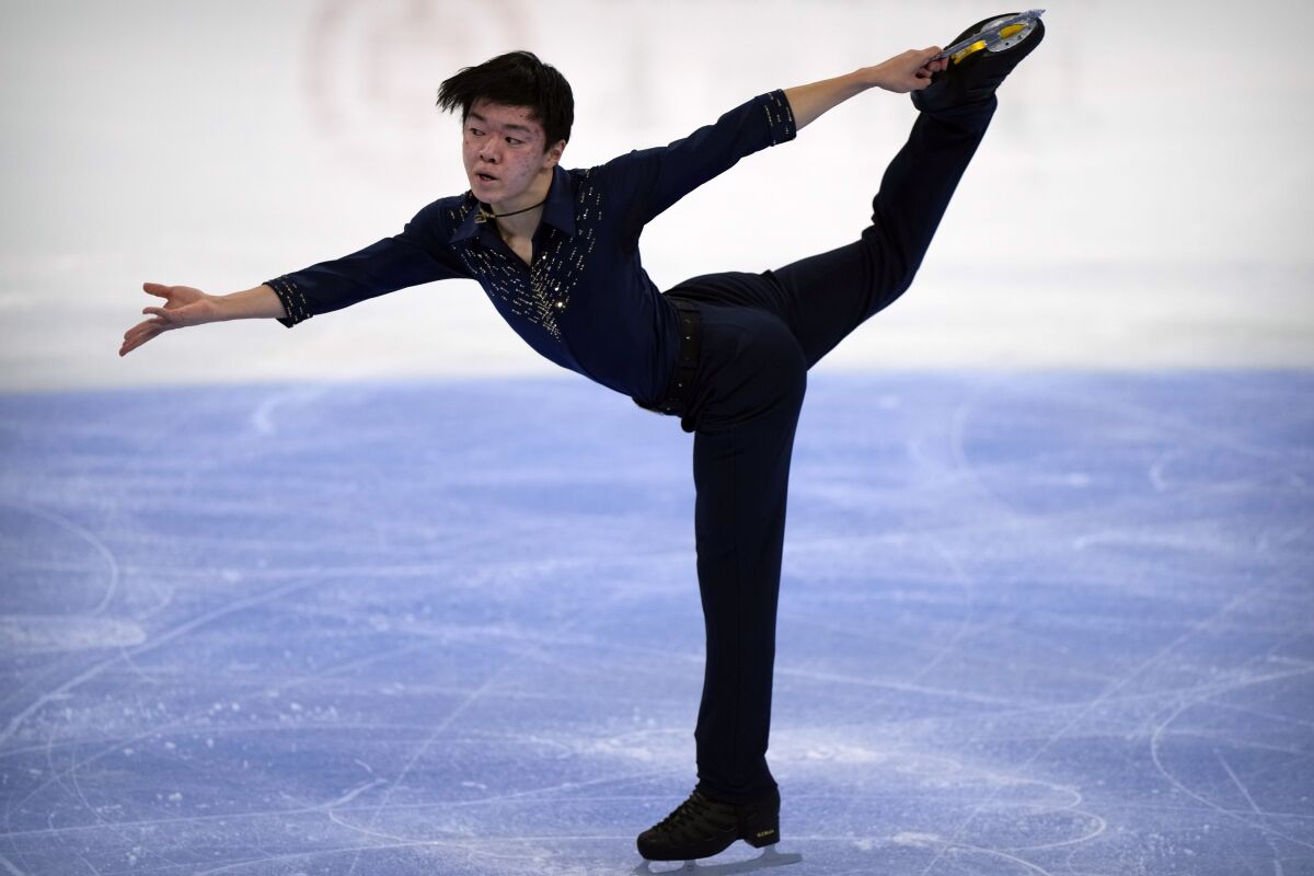 Yuma Kagiyama of Japan performs in the men's short program competition at the Asian Open Figure Skating Trophy, a test event for the 2022 Winter Olympics, at the Capital Indoor Stadium in Beijing, Thursday, Oct. 14, 2021. (AP Photo/Mark Schiefelbein)