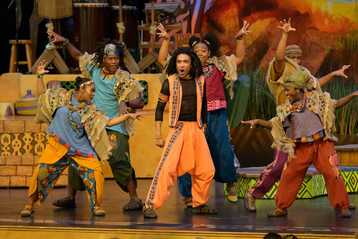 Performers in "Tale of the Lion King," a story, song and dance show, sing on stage.
