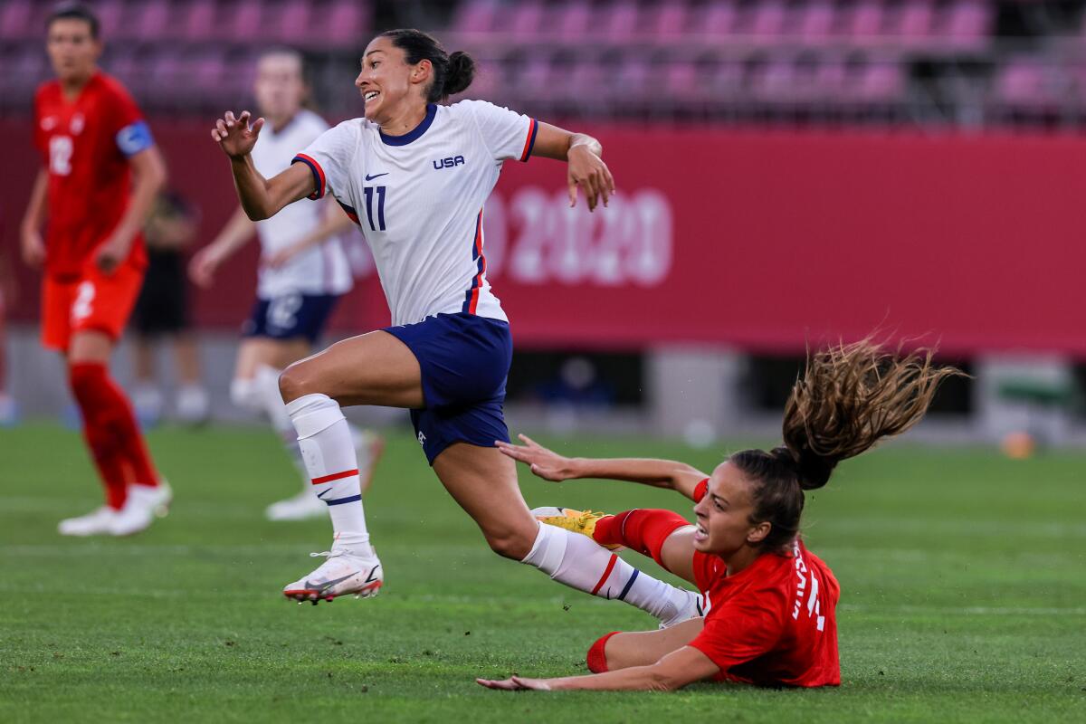 U.S. forward Christen Press (11) races past Canadian midfielder Julia Grosso (7) 