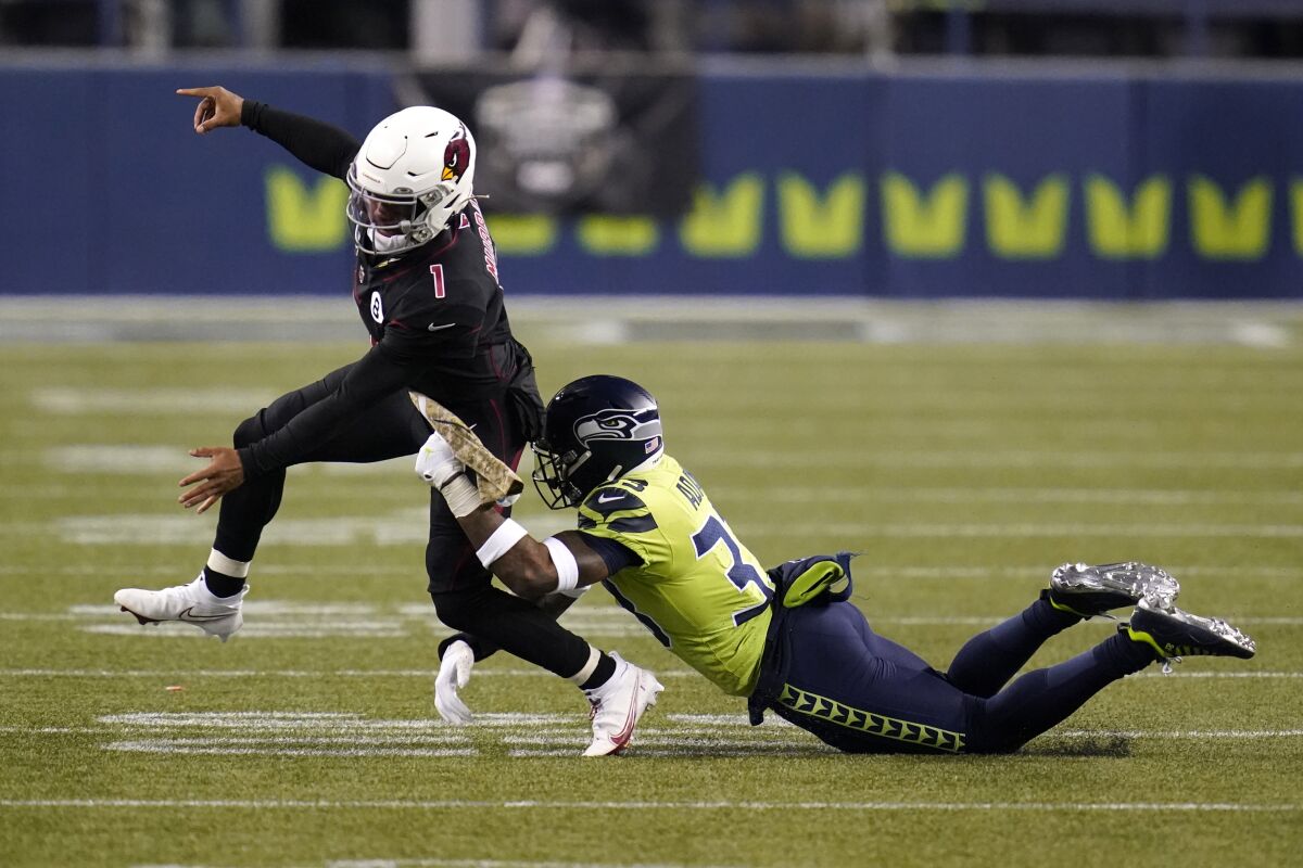 Seattle Seahawks strong safety Jamal Adams, right, gets to Arizona Cardinals quarterback Kyler Murray (1) just as Murray gets a pass off, during the second half of an NFL football game, Thursday, Nov. 19, 2020, in Seattle. (AP Photo/Elaine Thompson)