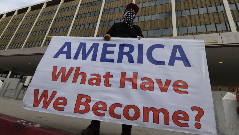 This sign at an immigrant rights groups protest Monday outside the federal courthouse in L.A. asks a timeless question.