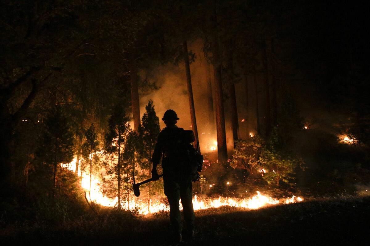 A firefighter watches the Rim fire near Yosemite National Park. The long-burning blaze, which began in mid-August, was a high-profile exception to an otherwise quiet fire season.