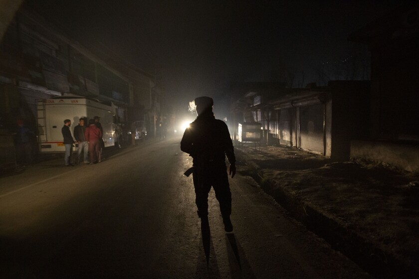 An Indian soldier guards near the site of an attack on the outskirts of Srinagar, Indian controlled Kashmir, Monday, Dec. 13, 2021. Many policemen were injured in an attack which police blamed on rebels fighting against Indian rule. (AP Photo/Mukhtar Khan)