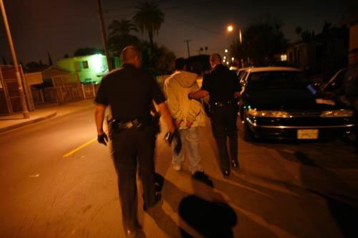 Maria Garcia's son is led away in handcuffs after a loaded shotgun was found in his room. The 17-year-old is an alleged member of Barrio Mojados and has been shot by rival gang members. Audio slide show >>>