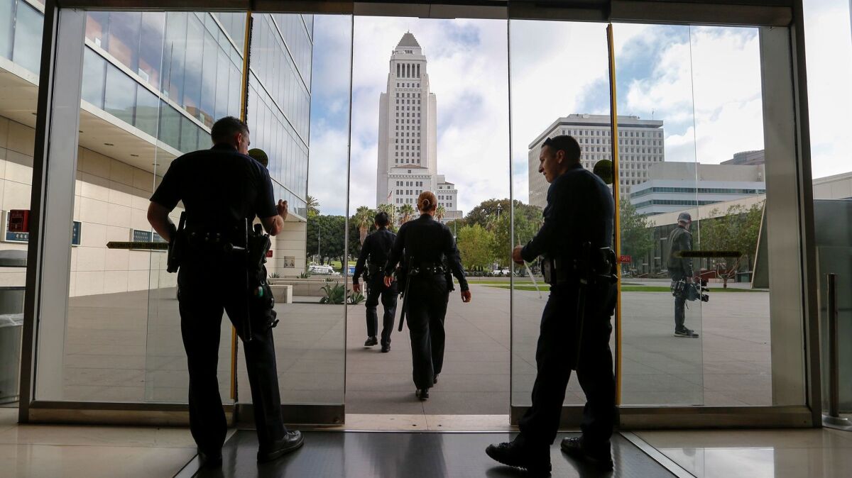 LAPD officers in the lobby of the department's downtown headquarters last fall. On Tuesday, the ACLU joined with a journalist, a professor and an activist in suing the LAPD over what they describe as a failure to meet the state's public records law.