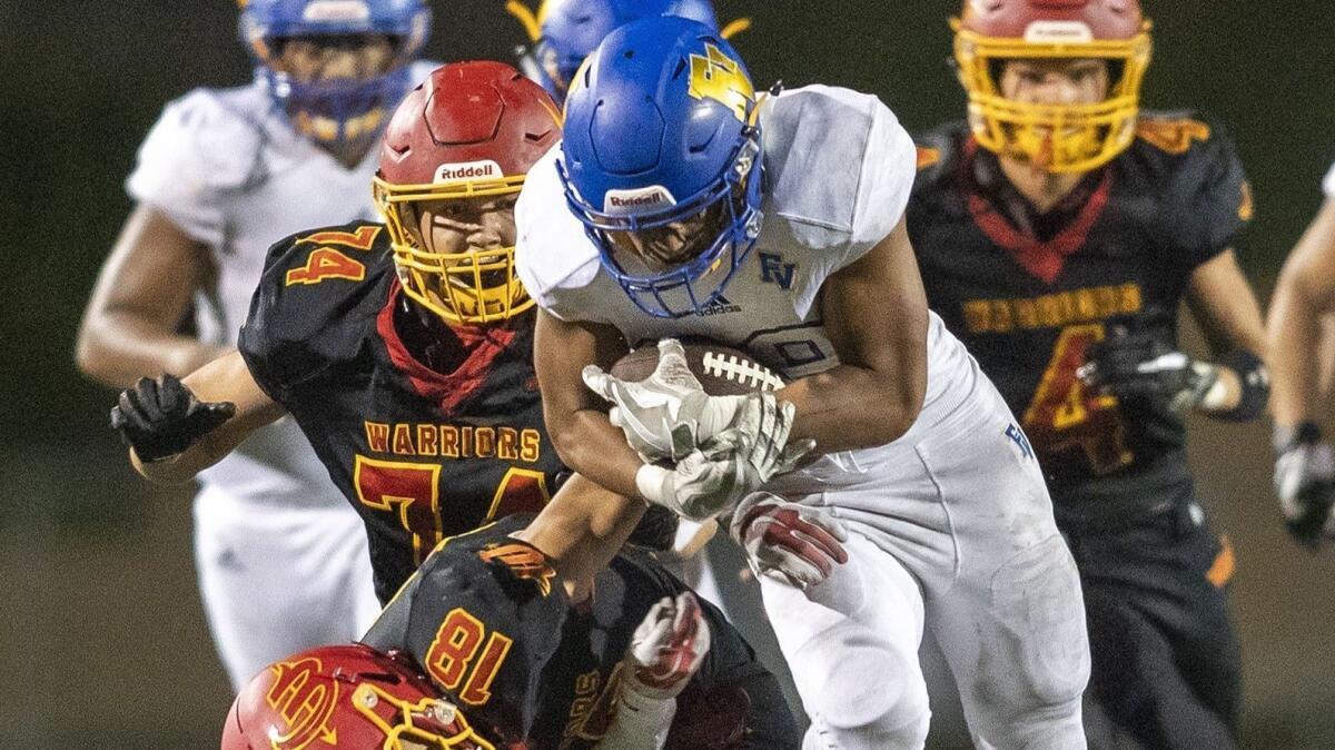 Fountain Valley High running back Mathew Fuiava runs over Woodbridge's Arriel Eaves in a nonleague game at University High on Friday. He rushed 18 times for 166 yards and two touchdowns.