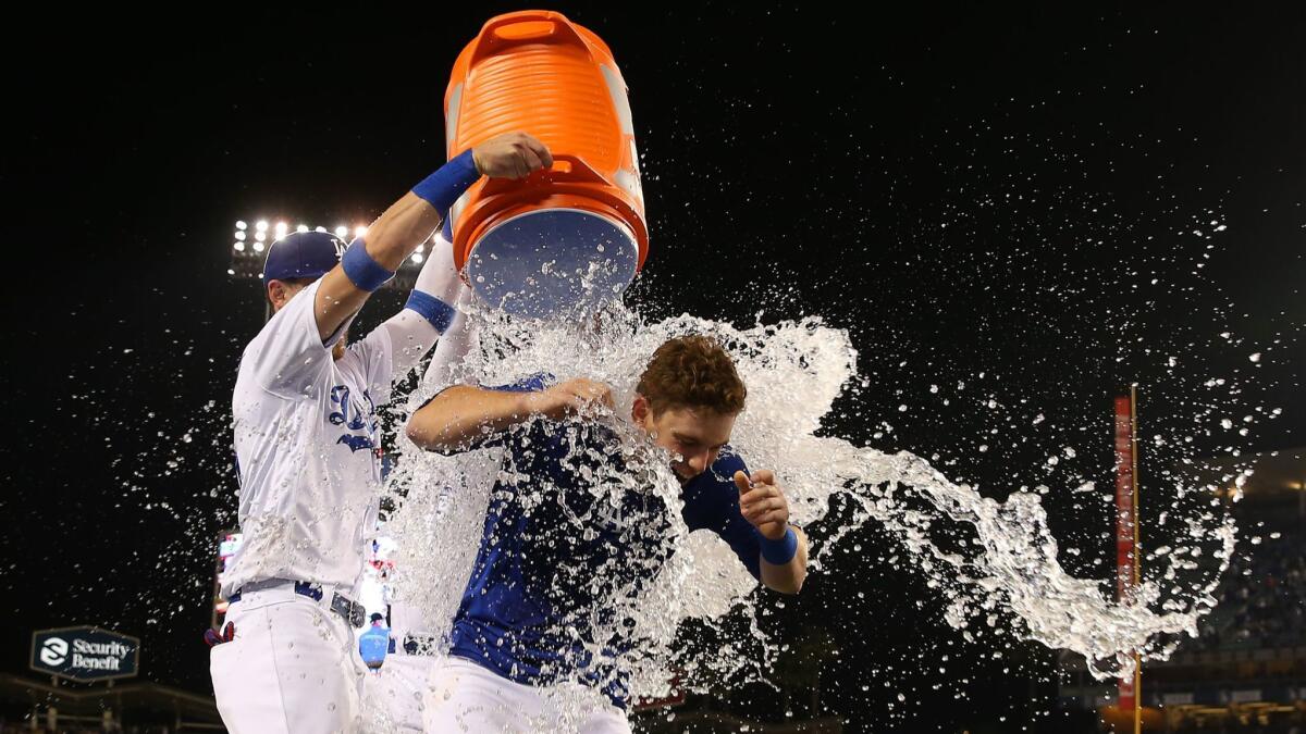 Dodgers catcher Will Smith is doused by teammates Cody Bellinger and Joc Pederson after hitting a walk-off homer against hte Phillies on June 1.