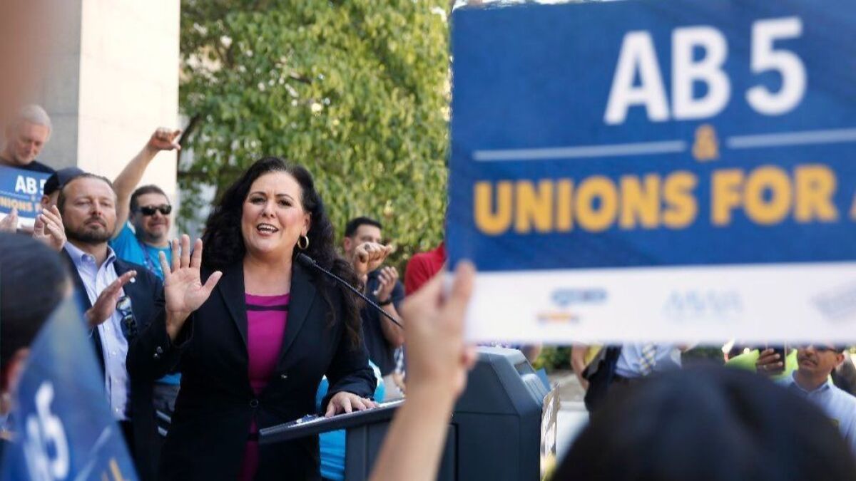 Assemblywoman Lorena Gonzalez (D-San Diego) speaks at a rally in July for her measure limiting when companies can label workers as independent contractors. The bill was passed and signed by Gov. Gavin Newsom in September, but it hasn't pleased everyone.