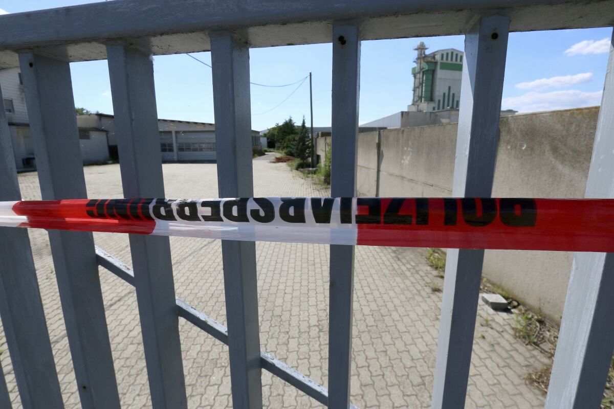 FILE - In this Sunday, July 5, 2020 file photo a propperty, where a man was shot dead on Saturday, July 4, 2021, is sealed off with a police tape in Gerasdorf, Austria. A Russian man went on trial Friday, Aug. 6, 2021 in Austria over the execution-style killing of a 43-year-old man in a Vienna suburb last year. (AP Photo/Ronald Zak, file)