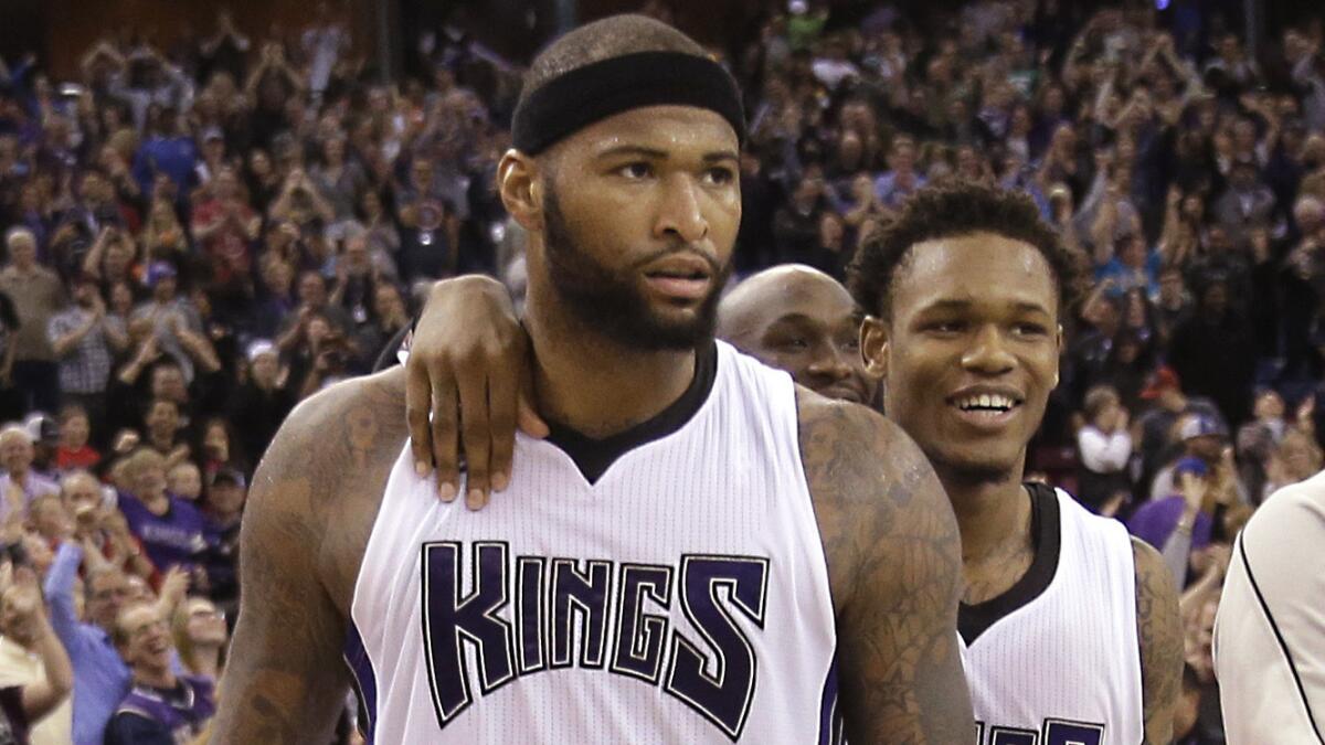 Sacramento Kings center DeMarcus Cousins, left, is congratulated by teammate Ben McLemore after scoring the winning basket in an 85-83 victory over the Phoenix Suns on Sunday.