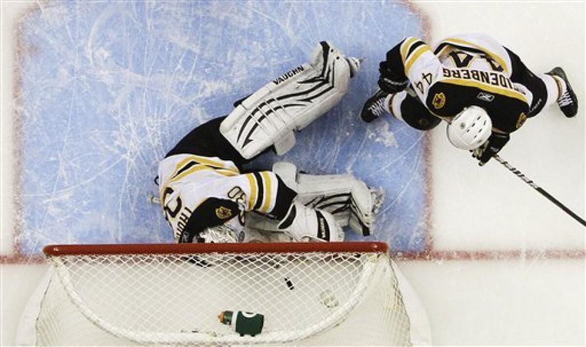 Boston Bruins goalie Tim Thomas makes a diving save as