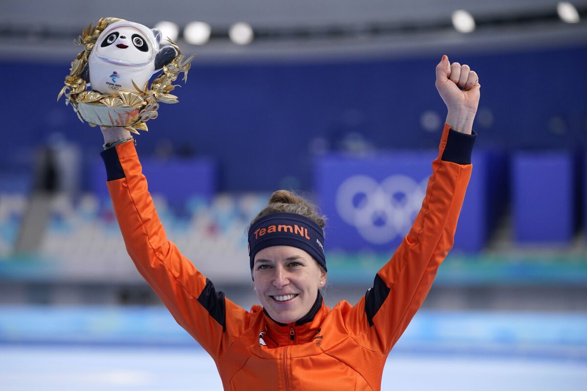 Ireen Wust of the Netherlands reacts during a flower ceremony after winning the gold medal and setting an Olympic record in the women's speedskating 1,500-meter race at the 2022 Winter Olympics, Monday, Feb. 7, 2022, in Beijing. (AP Photo/Sue Ogrocki)