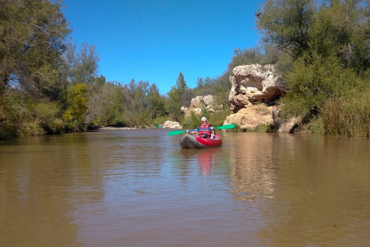 A person kayaking on the Verde River.