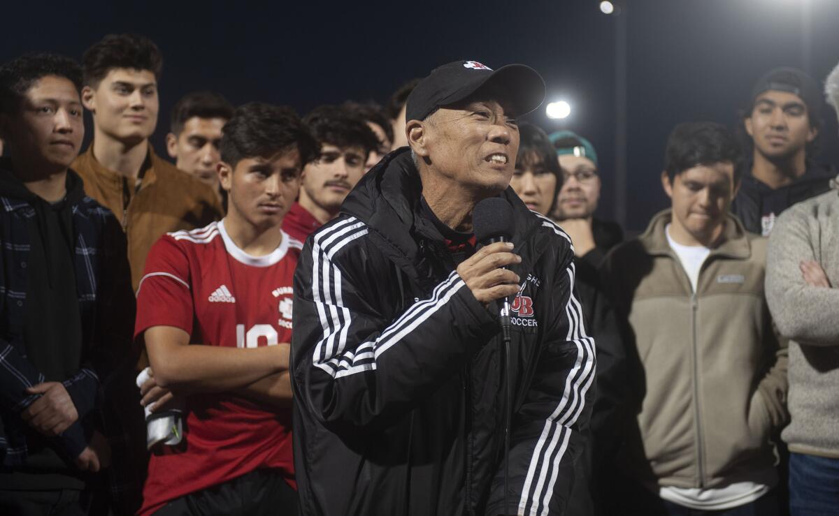 Burroughs High boys' soccer coach Mike Kodama speaks to attendees during Thursday's tribute at Memorial Field.