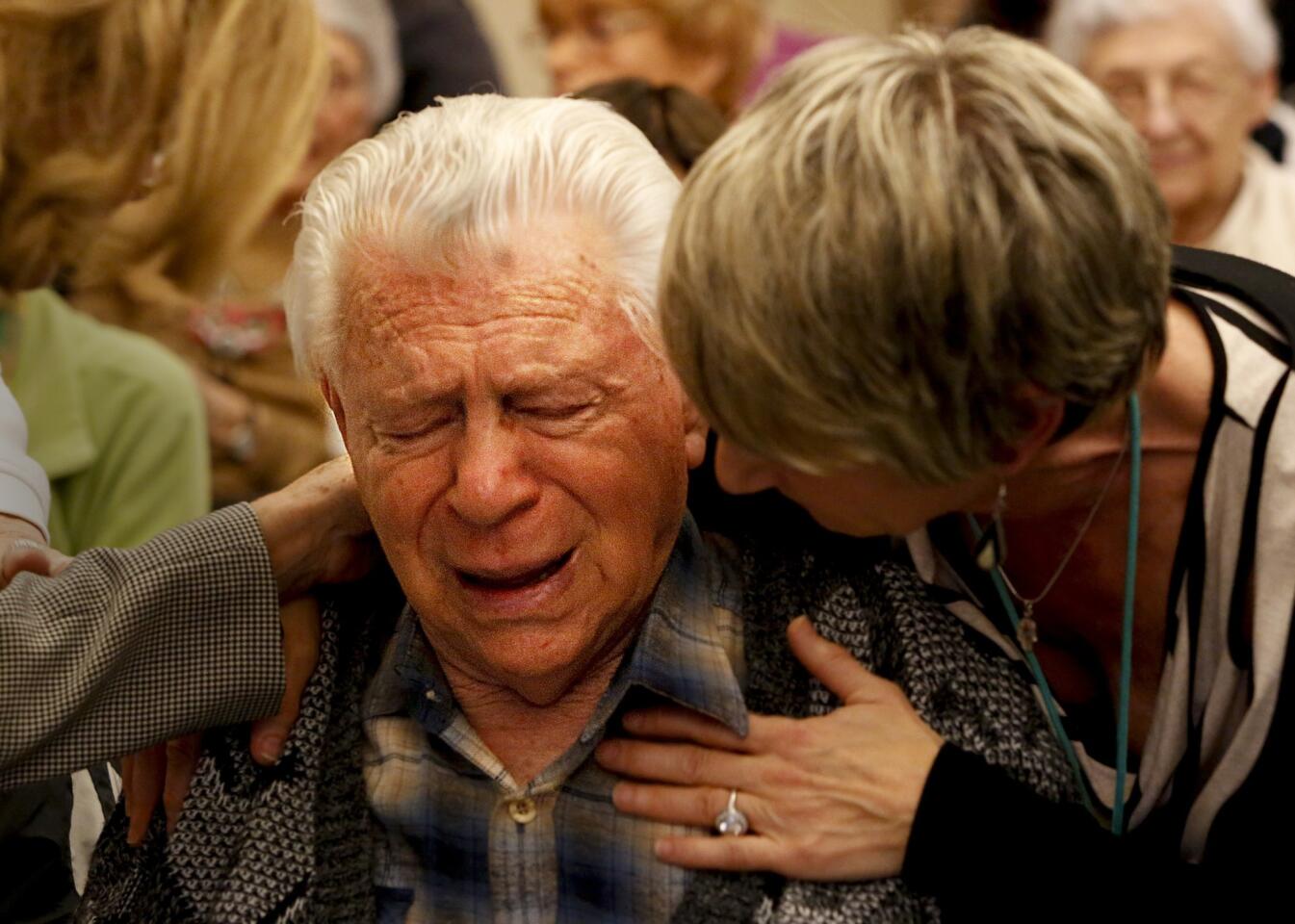 Holocaust survivor Ernest Braunstein is comforted by Betsey Windmuller Roberts after a play about Jewish refugees' ill-fated ocean journey was performed at the Los Angeles Jewish Home in Reseda.