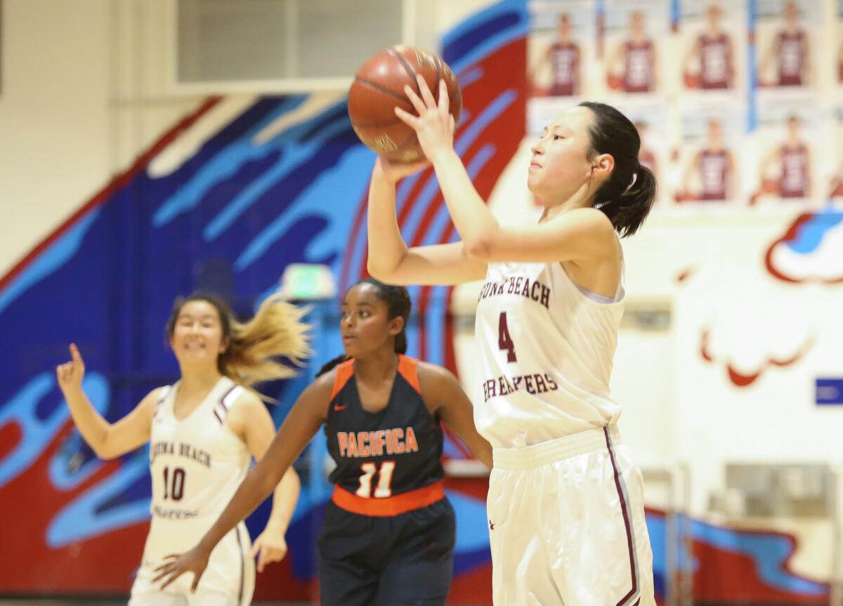 Laguna Beach's Anna Cheng (4) makes a three-pointer in a nonleague game against Pacifica Christian Orange County on Friday.