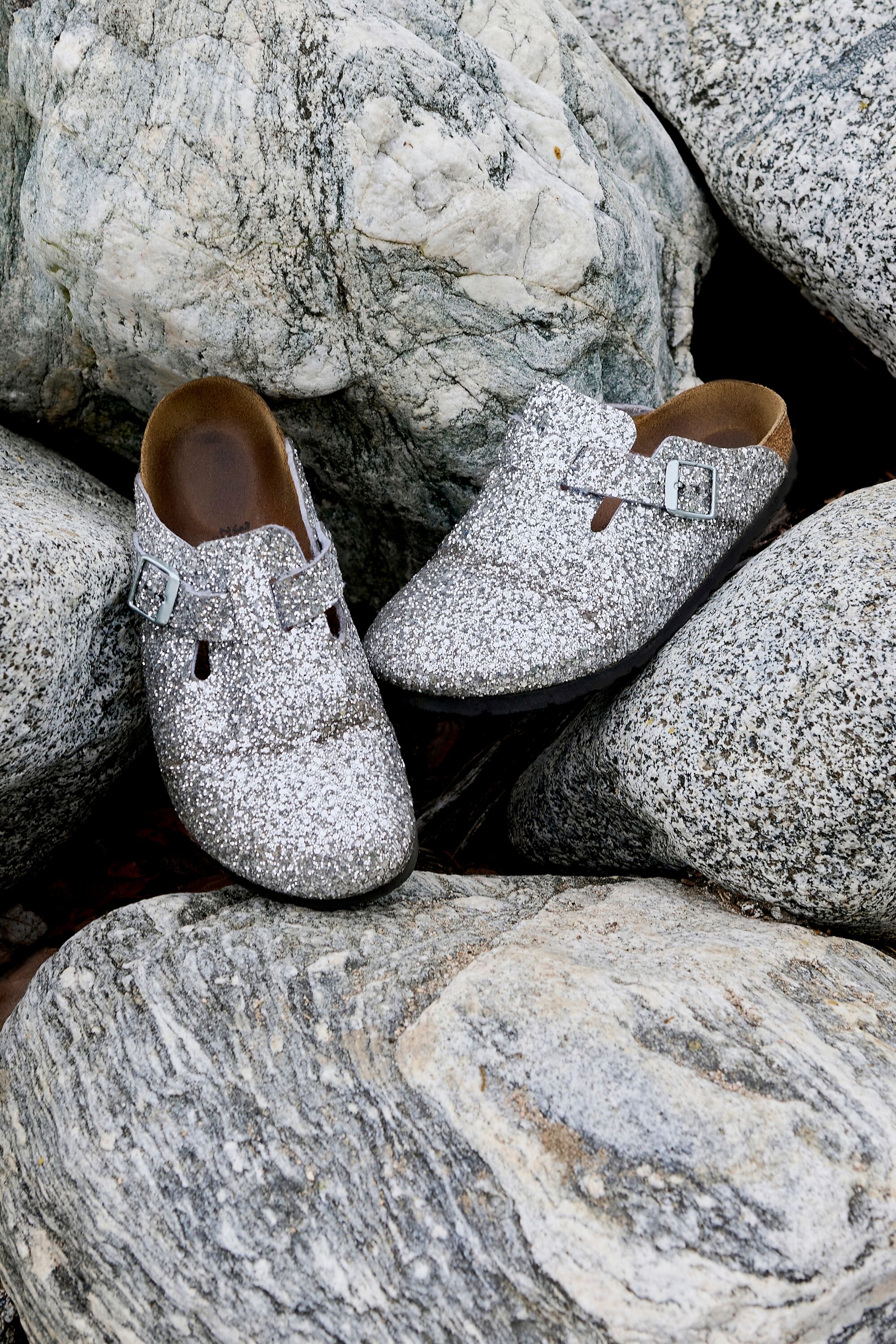 A pair of Boston sandals on rocks.