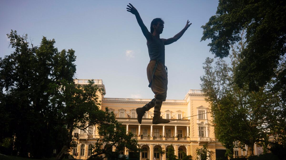 An acrobat walks on a tightrope in downtown Sofia, Bulgaria