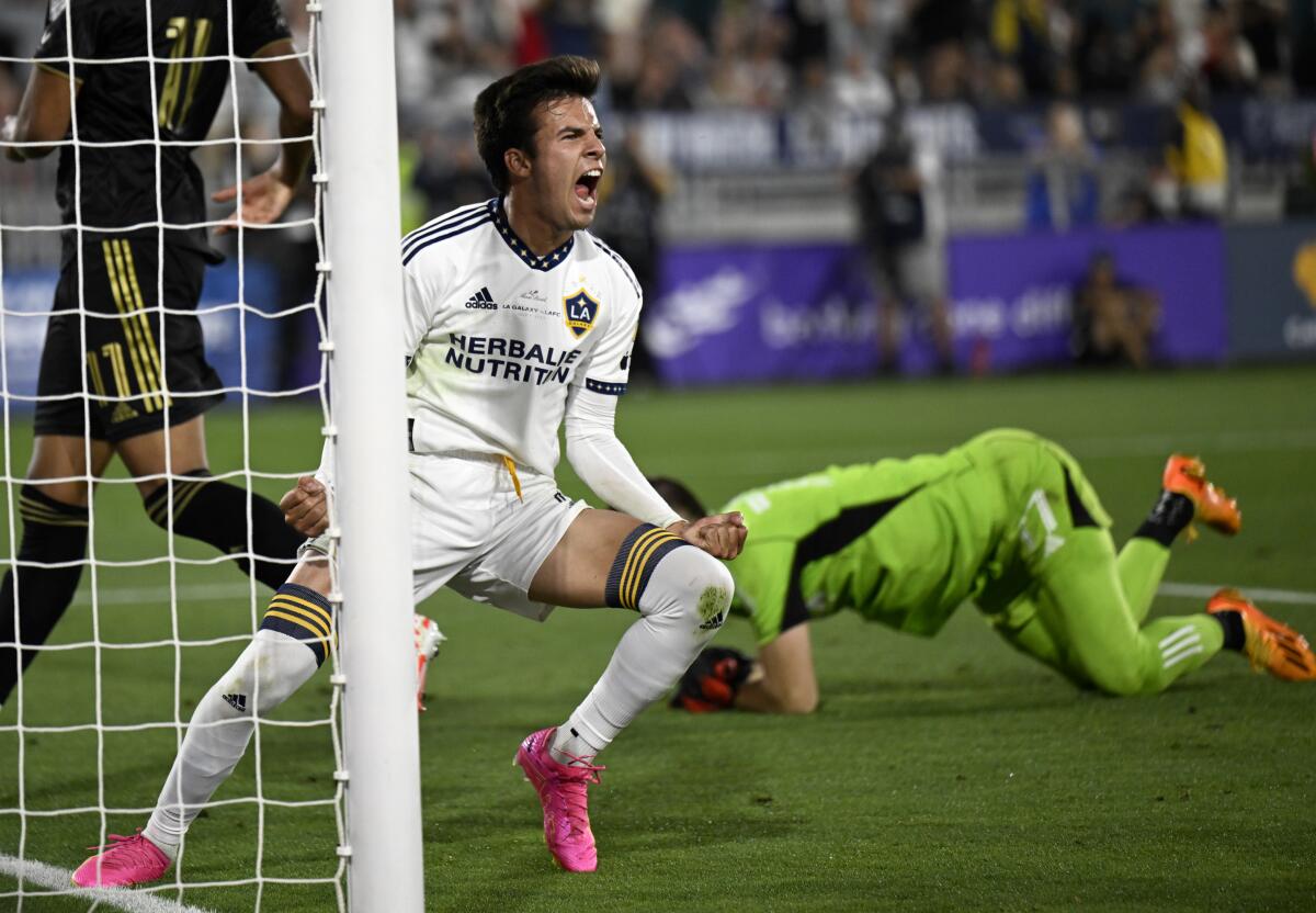 Galaxy midfielder Riqui Puig celebrates after scoring against LAFC goalkeeper John McCarthy.