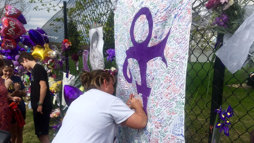 Fans outside Paisley Park in Chanhassen, Minn., left messages on a memorial sheet adorned with the symbol Prince once used to identify himself.