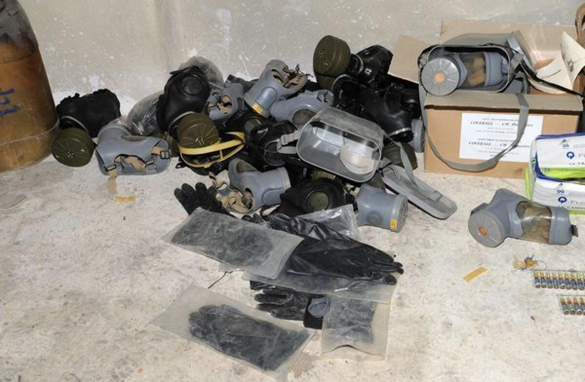A handout picture released by the Syrian Arab News Agency on Saturday shows gas masks allegedly found in Jobar on the outskirts of the capital, Damascus, alongside what the Syrian government claims to be materials used to make chemical weapons.