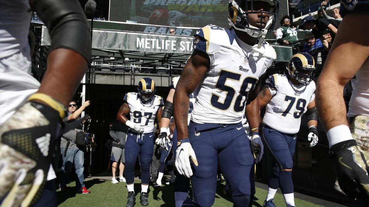 Cory Littleton (58) runs on to the field with Rams defensive players before a game against the New York Jets at MetLife Stadium.