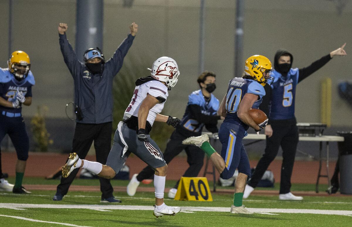 Marina's Brantt Riederich runs 89 yards for a touchdown as Ocean View's Anthony Ramirez gives pursuit on Wednesday.