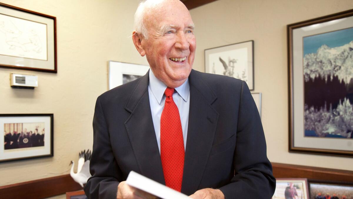 Cecil V. Andrus smiles at his office in Boise, Idaho, on Oct. 14, 2001.