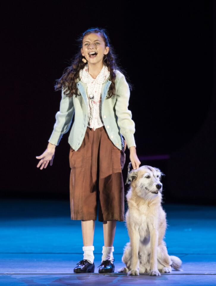 Kaylin Hedges as Annie and Macy as her dog Sandy on stage in "Annie" at the Hollywood Bowl on July 27, 2018.