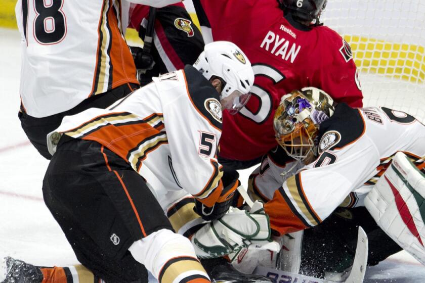 Senators right wing Bobby Ryan is sent crashing into Ducks goalie Ilya Bryzgalov by right wing Tim Jackman (18) and left wing Dany Heatley during their game Friday night in Ottawa.