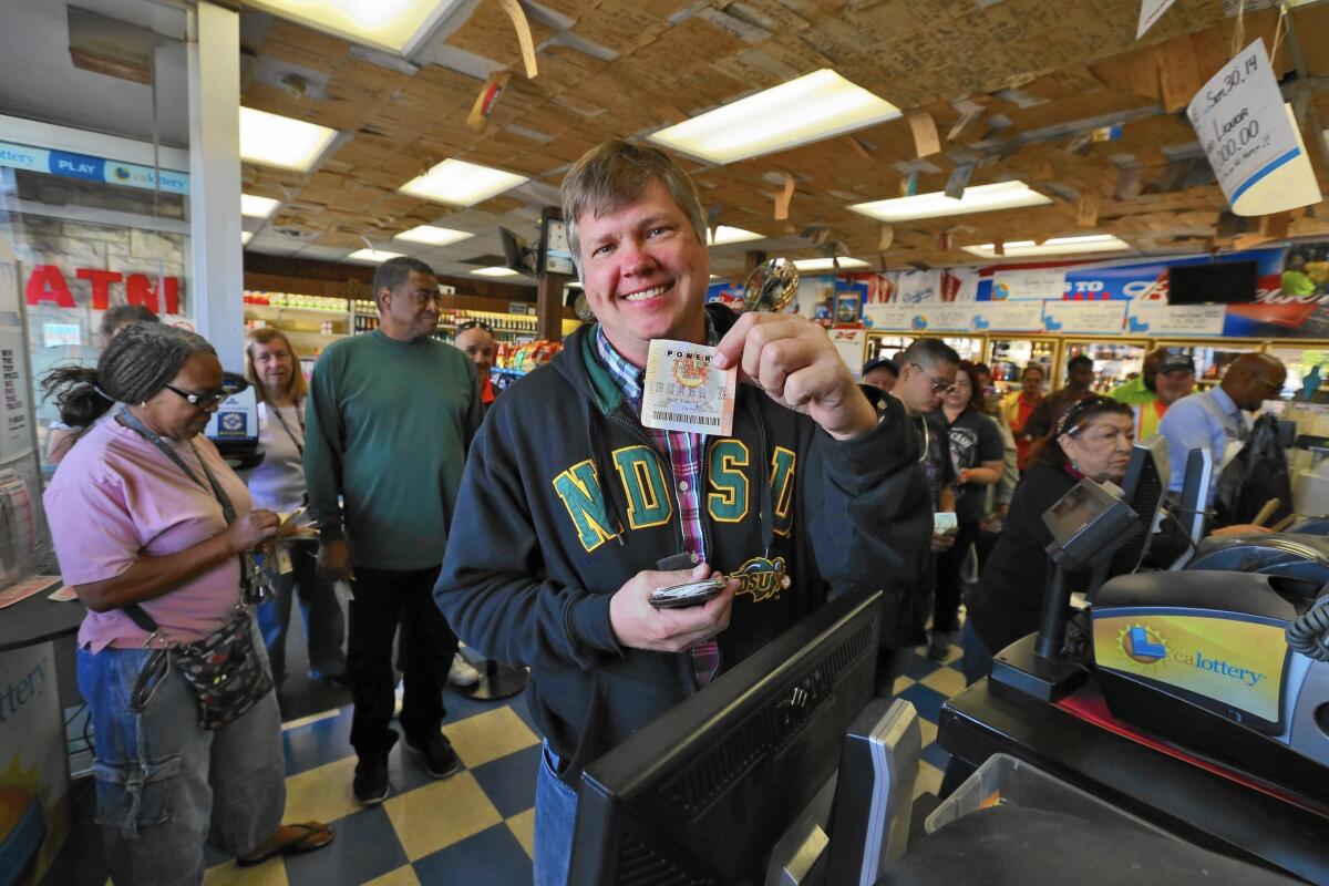 Mark Boesen displays his Powerball lottery tickets at the Bluebird liquor store in Hawthorne.