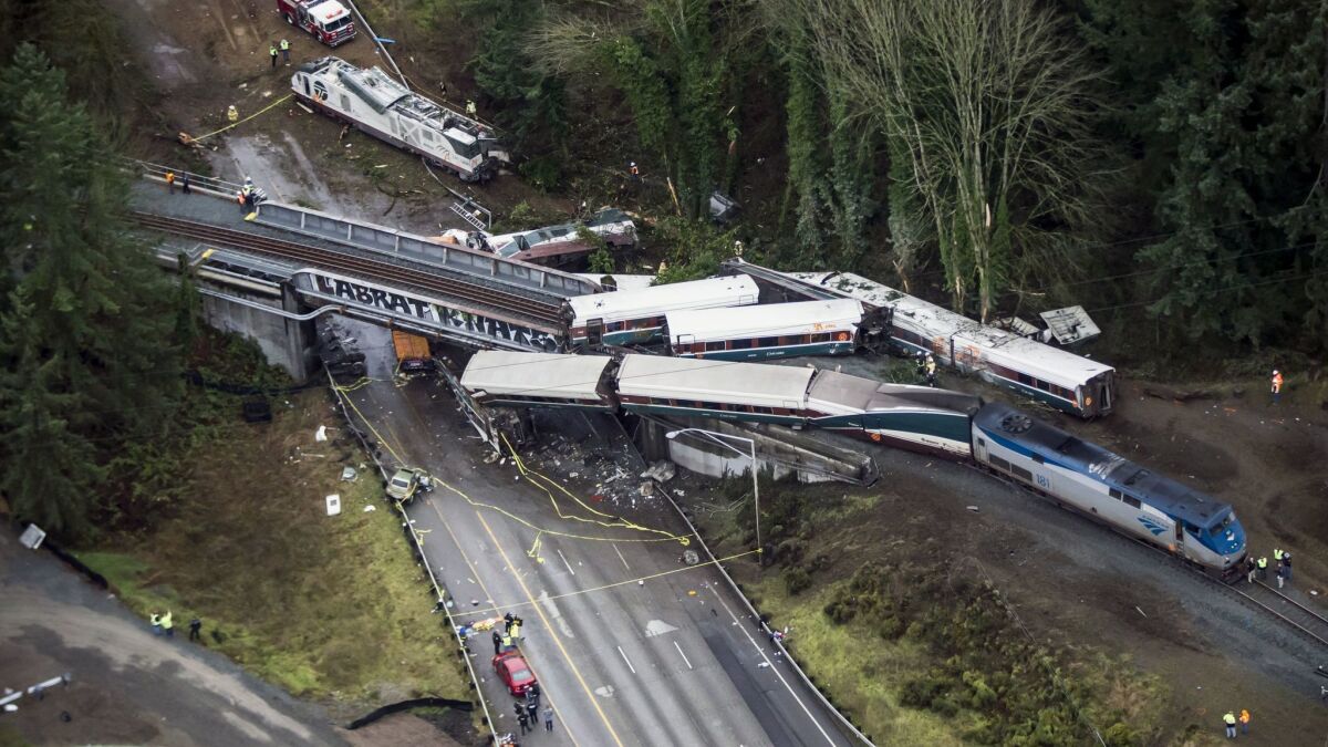 Cars from an Amtrak train lie on Interstate 5 in DuPont, Wash., after derailing.