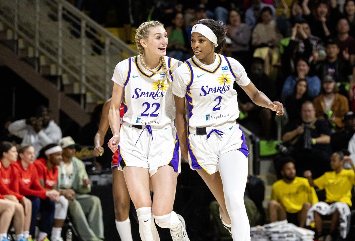 Sparks forwards Cameron Brink, left, and Rickea Jackson run shoulder to shoulder up the court.