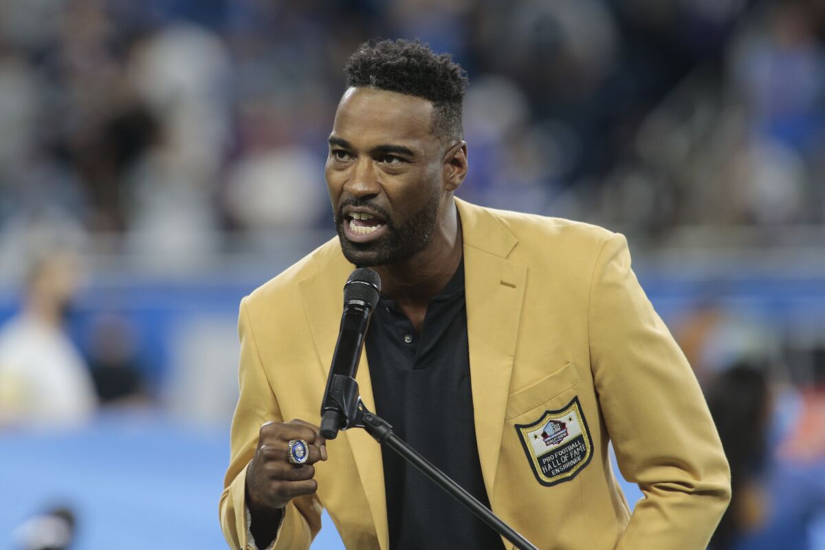 Former Detroit Lions wide receiver Calvin Johnson speaks after being presented his Hall of Fame ring during halftime of an NFL football game against the Baltimore Ravens in Detroit, Sunday, Sept. 26, 2021. (AP Photo/Tony Ding)