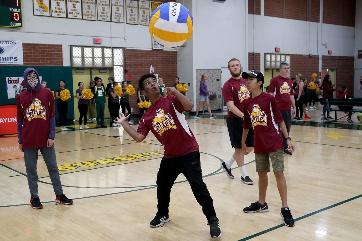 Ocean View High senior Trevor Payne, 17, center, serves the ball during Thursday's volleyball tournament at Edison High. 