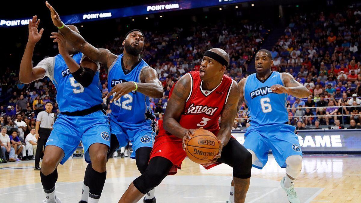 Trilogy's Al Harrington (3) is guarded by three Power players as he attempts to drive to the basket during a BIG3 game.