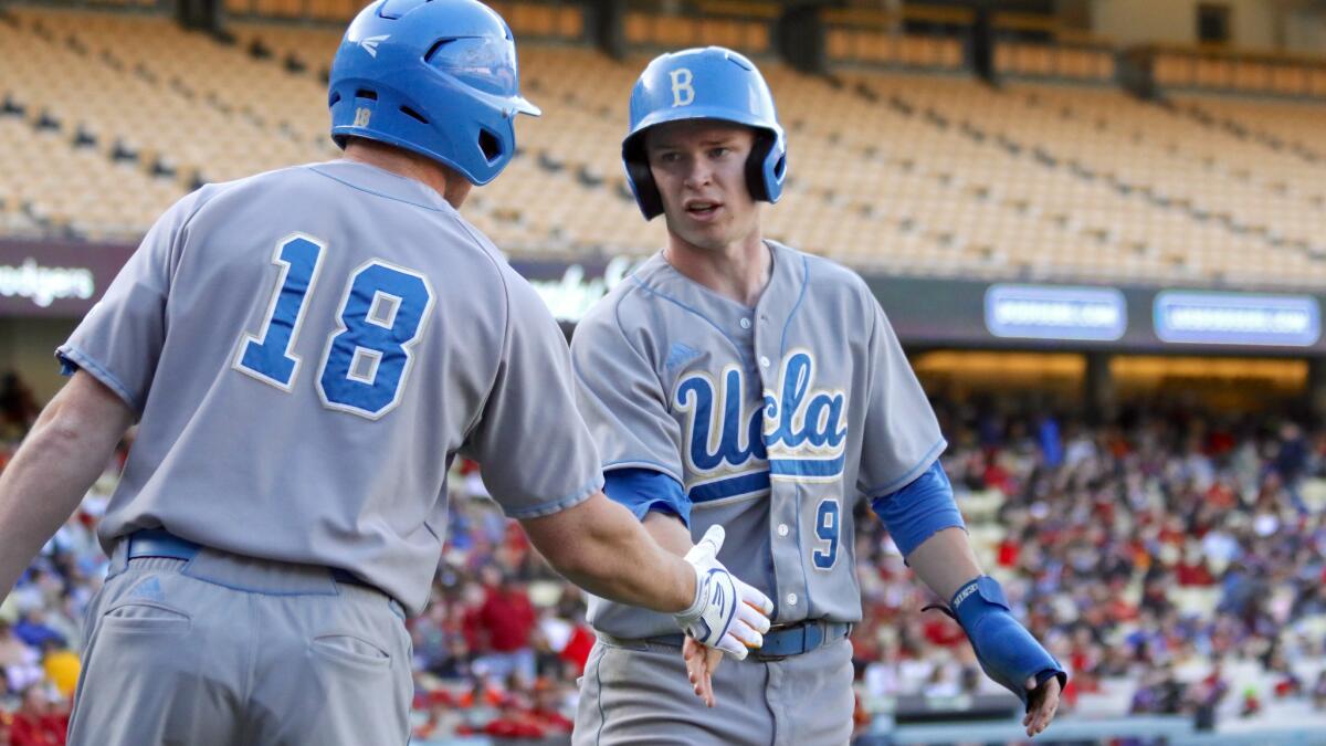 UCLA outfielder Brett Stephens is congratulated after scoring a run against USC at Dodger Stadium. Stephens had four hits, two RBIs and scored the game-winning run.
