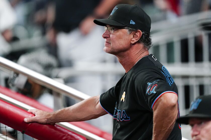 Miami Marlins manager Don Mattingly looks on from the dugout during a baseball game against the Atlanta Braves, Friday, Sept. 2, 2022, in Atlanta. (AP Photo/John Bazemore)